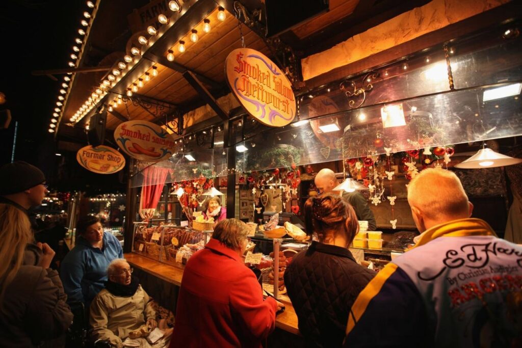 Birmingham Christmas Market: Traditional German-style wooden stalls selling festive food and drink at Birmingham Frankfurt Christmas Market.
