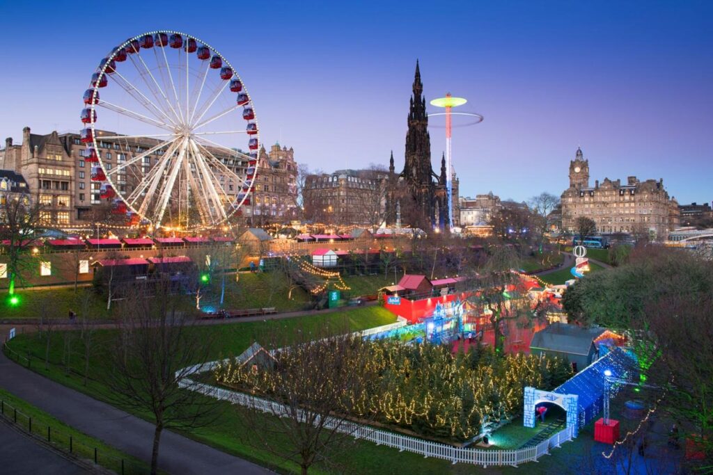 Edinburgh Christmas Market - a view of the multi-coloured market stalls and Ferris wheel
